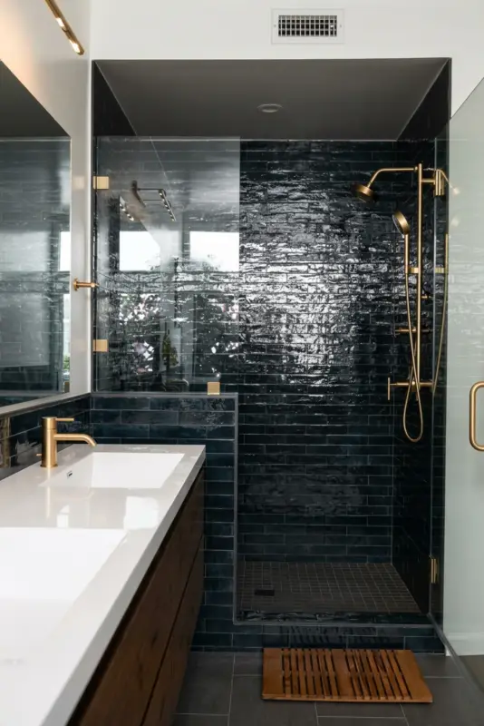 Blue tiled shower with brass hardware