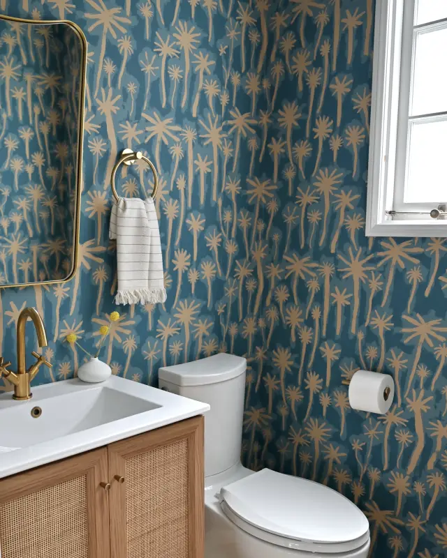 Powder room with moody tile and brass accents