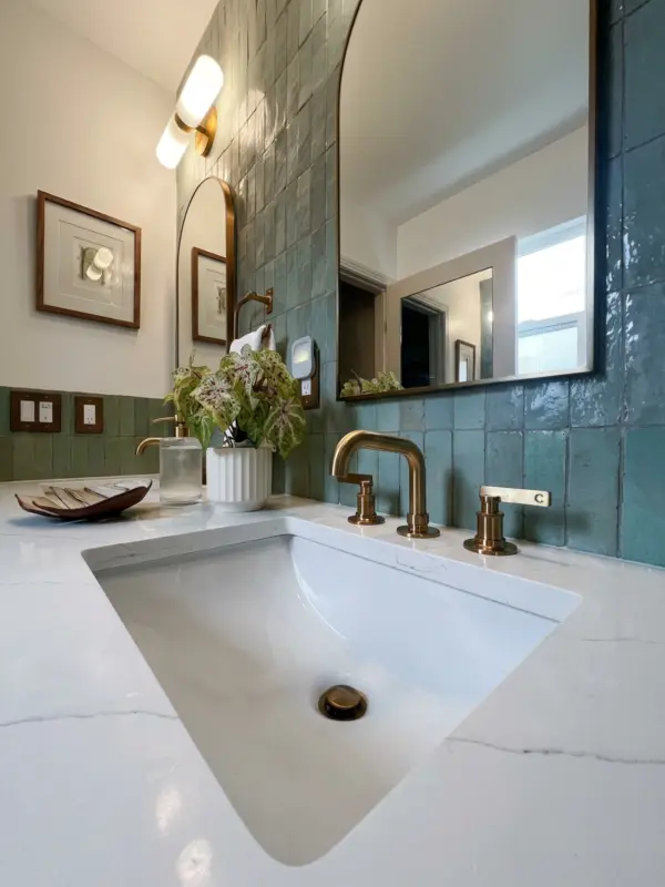 Double vanity with arched mirrors under a skylight