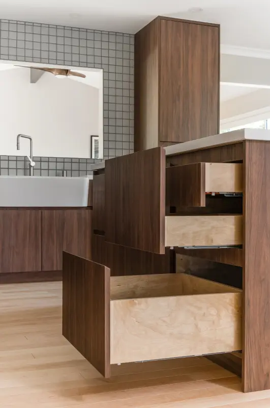 Walnut island with soft-close drawers open to show plywood drawer boxes