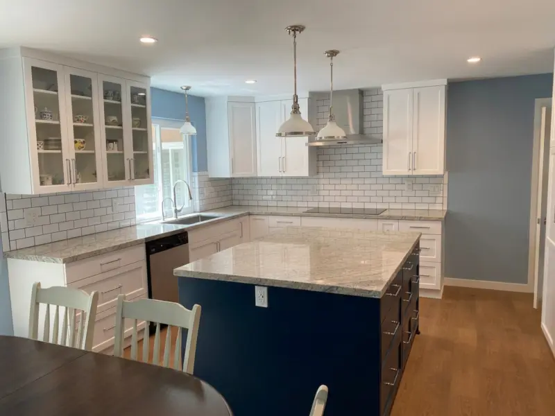 White and blue shaker kitchen with natural stone counters